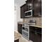 Double oven, granite countertops, and dark wood cabinets at 4540 Sequel Rd, Kissimmee, FL 34746