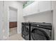 Spacious laundry room with washer, dryer, and storage at 4540 Sequel Rd, Kissimmee, FL 34746