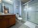 Bathroom featuring tile flooring, toilet, glass enclosed shower, and vanity at 4557 Ada Ln, Kissimmee, FL 34746