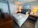 Well-lit bedroom with nautical themed bedding, dark wood floors and lamps at 4557 Ada Ln, Kissimmee, FL 34746