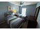 Bright bedroom with two twin beds, artwork and wood floors at 4557 Ada Ln, Kissimmee, FL 34746