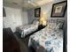 Comfortable bedroom with two twin beds, nautical themed bedding and neutral walls at 4557 Ada Ln, Kissimmee, FL 34746
