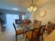 Elegant dining room with modern lighting and seating, seamlessly connected to the living area for entertaining at 4557 Ada Ln, Kissimmee, FL 34746