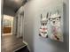 Upstairs hallway featuring modern artwork, with a peek into the adjacent bathroom at 4557 Ada Ln, Kissimmee, FL 34746