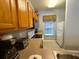 Bright kitchen featuring modern appliances, wood cabinets, neutral countertops, and a tiled floor at 4557 Ada Ln, Kissimmee, FL 34746