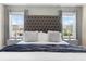 Main bedroom with king bed, tufted headboard, and large windows at 4818 Memories Ln, Kissimmee, FL 34746