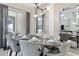 Bright dining room with large table, modern light fixture, and access to a patio at 4818 Memories Ln, Kissimmee, FL 34746