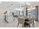 Dining room with oval table, six chairs, and modern lighting at 4818 Memories Ln, Kissimmee, FL 34746