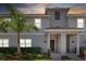 Townhouse exterior at dusk with gray siding and landscaping at 4818 Memories Ln, Kissimmee, FL 34746
