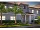 Townhouse exterior at sunset with gray siding and landscaping at 4818 Memories Ln, Kissimmee, FL 34746