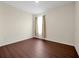 Bright bedroom featuring wood-look flooring and window at 504 Talisi Loop, St Cloud, FL 34771