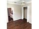 This bedroom has wood flooring, a ceiling fan, a closet, and an entrance to the kitchen at 510 Maryland Ave, St Cloud, FL 34769