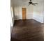 Cozy living room with ceiling fan, dark hardwood floors, and natural light at 510 Maryland Ave, St Cloud, FL 34769