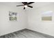 Bright bedroom with gray wood-look floors and ceiling fan at 5265 Letha St, Orlando, FL 32811