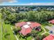 Aerial view of a townhouse with red tile roof and lush landscaping at 540 Hunter Cir, Kissimmee, FL 34758