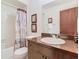 Clean bathroom with tub, toilet, and wood vanity at 540 Hunter Cir, Kissimmee, FL 34758