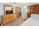 Bright bedroom with dresser, full-size bed and view of living room at 540 Hunter Cir, Kissimmee, FL 34758