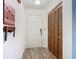 Bright entryway with wood-look floors, coat closet, and door to exterior at 540 Hunter Cir, Kissimmee, FL 34758