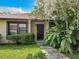 Exterior view of a townhouse entrance with lush landscaping at 540 Hunter Cir, Kissimmee, FL 34758
