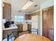 Galley kitchen with wood cabinets, white countertops, and adjacent dining area at 540 Hunter Cir, Kissimmee, FL 34758