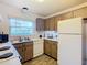 Cozy kitchen offers ample counter space and wood cabinets at 540 Hunter Cir, Kissimmee, FL 34758