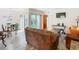 Living room features brown leather sofas, wood-look floors, and patio access at 540 Hunter Cir, Kissimmee, FL 34758