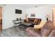 Living area with brown leather couches, wood floors and a wall-mounted TV at 540 Hunter Cir, Kissimmee, FL 34758