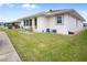 Landscaped backyard with patio and green lawn at 580 Teesdale, Haines City, FL 33844