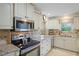 Bright kitchen with granite countertops and updated cabinetry at 580 Teesdale, Haines City, FL 33844