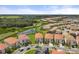 Aerial view of a community featuring houses with tile roofs and lush landscaping at 6052 Broad Oak Dr, Davenport, FL 33837