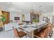 Open concept dining room with large table and modern pendant lighting at 6052 Broad Oak Dr, Davenport, FL 33837
