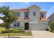 Two story house with a two car garage at 6052 Broad Oak Dr, Davenport, FL 33837