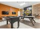Game room with foosball, air hockey, and Harley Davidson theme at 6052 Broad Oak Dr, Davenport, FL 33837