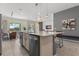 Modern kitchen with large island, stainless steel appliances, and breakfast bar at 6052 Broad Oak Dr, Davenport, FL 33837