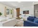 Bright living room featuring comfortable seating and large TV at 6052 Broad Oak Dr, Davenport, FL 33837