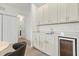 Wet bar with wine cooler and cabinetry at 6052 Broad Oak Dr, Davenport, FL 33837