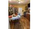 Eat-in kitchen boasts warm yellow walls, brown cabinets, modern appliances, and a wood-look floor at 704 N 8Th St, Haines City, FL 33844