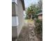 Side yard with a concrete walkway and some landscaping at 704 N 8Th St, Haines City, FL 33844