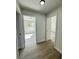 Hallway with doors to bedrooms and wood-look flooring at 7450 Crooked Lake Cir, Orlando, FL 32818