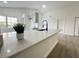 Modern kitchen island with white quartz countertop and black faucet at 7450 Crooked Lake Cir, Orlando, FL 32818