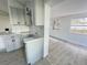 Open kitchen with gray cabinets, island, and view into living room at 7450 Crooked Lake Cir, Orlando, FL 32818