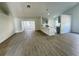 Open concept living room with hardwood floors and kitchen view at 7450 Crooked Lake Cir, Orlando, FL 32818