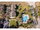 Aerial view of community pool, townhomes, and lush landscaping, providing a resort-like atmosphere at 7588 Assembly Ln, Reunion, FL 34747
