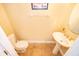 A quaint half bathroom featuring a pedestal sink and tiled floors at 7588 Assembly Ln, Reunion, FL 34747