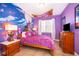 Themed bedroom with colorful decor, plush bedding, and whimsical accents at 7588 Assembly Ln, Reunion, FL 34747