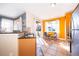 Bright kitchen featuring a cozy breakfast nook and stainless steel appliances at 7588 Assembly Ln, Reunion, FL 34747