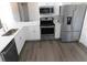 Modern kitchen featuring stainless steel appliances and white shaker cabinets at 1972 S Old Mill Dr, Deltona, FL 32725