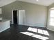 Bright living room with vaulted ceiling, dark laminate floors, and large windows at 1972 S Old Mill Dr, Deltona, FL 32725