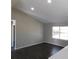 Living room with vaulted ceiling, dark laminate floors, and a view to the kitchen at 1972 S Old Mill Dr, Deltona, FL 32725