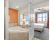 Main bathroom with corner bathtub and bedroom access at 12538 Floridays Resort Dr # 411, Orlando, FL 32821